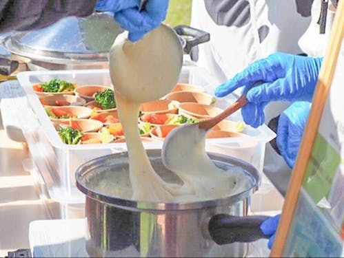 先輩隊員の濱田さんがイベントでチーズフォンデュの試食を実施したときの様子