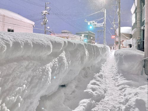 除雪車で寄せた雪が高く積もり、歩道に壁ができました