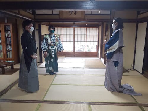 狂言体験のようす(左が山口鷺流狂言保存会メンバー)