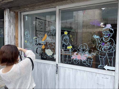 滞在期間中に出会った人たちをまちなかのガラスに描いてくれました
