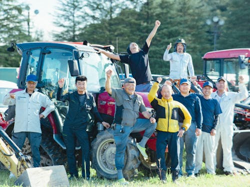 職員の皆さん。敷地内に並ぶ大型車両の前で