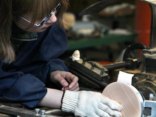 馬路地区で「木工の技術継承」のため木工職人見習いとして頑張っている大塚さん。「ろくろ」と呼ばれる機械を使って研磨をしているところ。