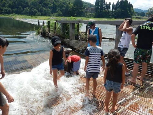 夏のやな場で遊ぶ子供たち