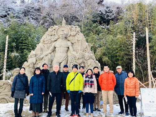 お試し移住モニターツアーにて現協力隊サンドアートアーティストの 保坂俊彦さん制作の砂像『鼓動』前にて集合写真