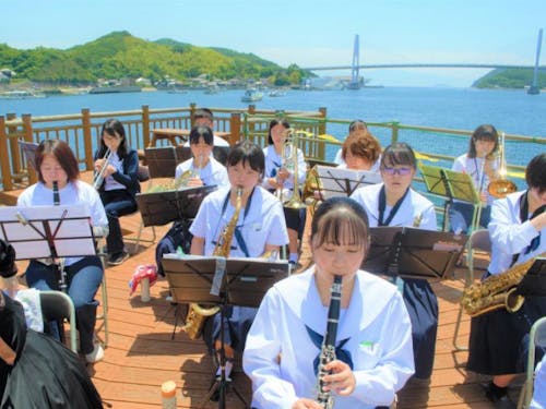 町のお祭りにて地域の大人と高校生による合同演奏会