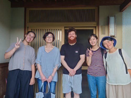 体験住宅の玄関先で、住宅利用者と移住体験ツアー参加者で